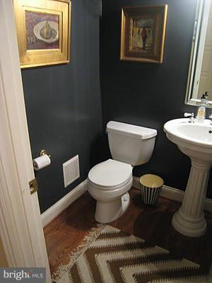 708 Tolbert Drive Odenton, MD 21113 - Photo 8 of 21 a white toilet sitting next to a bathroom sink and a mirror