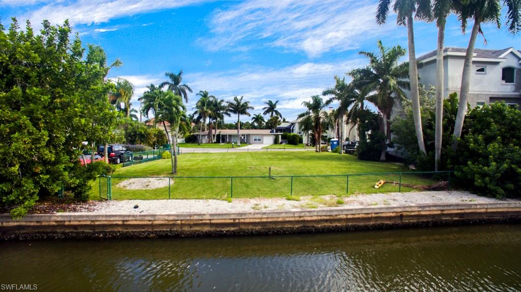 388 Pine Avenue Naples, FL 34108 - Photo 5 of 10 a view of swimming pool with a yard and lake view