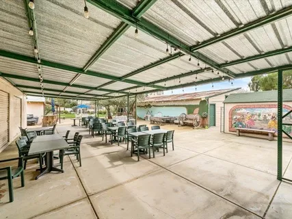 a view of kitchen with stainless steel appliances kitchen island granite countertop lots of counter top space