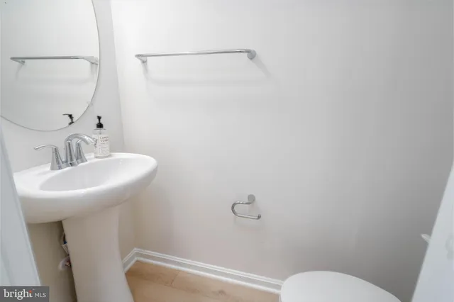 a bathroom with a sink toilet and a mirror