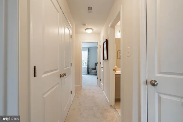 a view of a hallway with wooden shelves