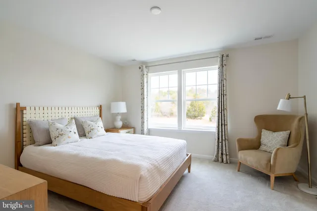 a bedroom with a bed and a couch