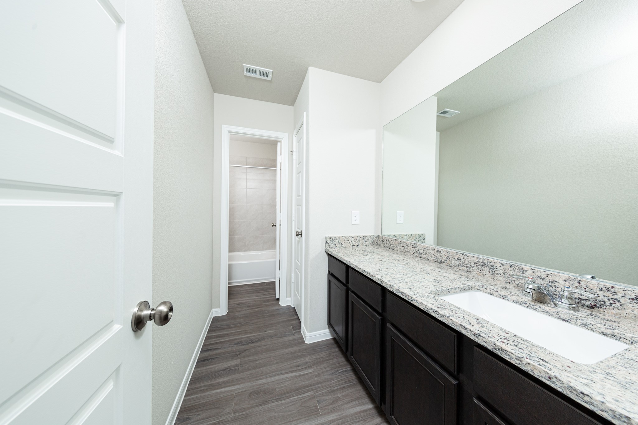 3042 Nickell Back Drive Conroe, TX 77301 - Photo 15 of 24 a bathroom with a granite countertop sink and a mirror