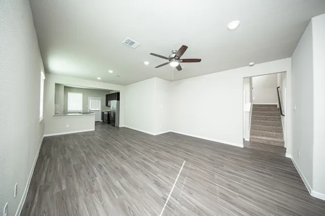 a view of an empty room and wooden floor