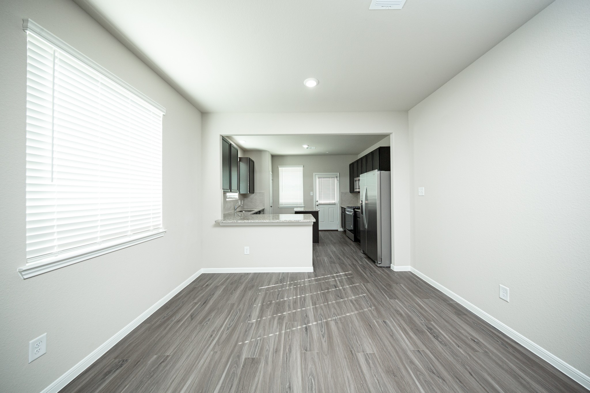 3042 Nickell Back Drive Conroe, TX 77301 - Photo 6 of 24 a view of a kitchen with wooden floor and a kitchen
