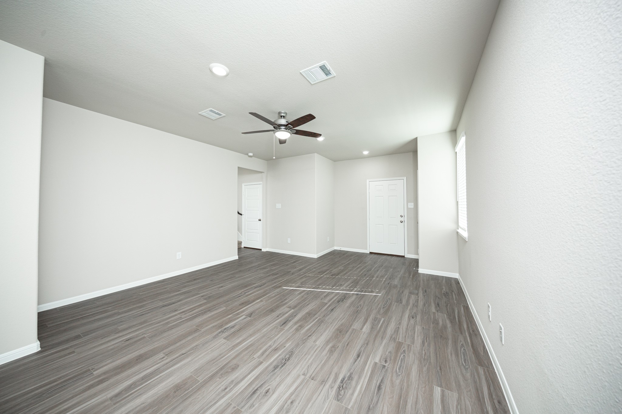 3042 Nickell Back Drive Conroe, TX 77301 - Photo 7 of 24 an empty room with wooden floor and windows
