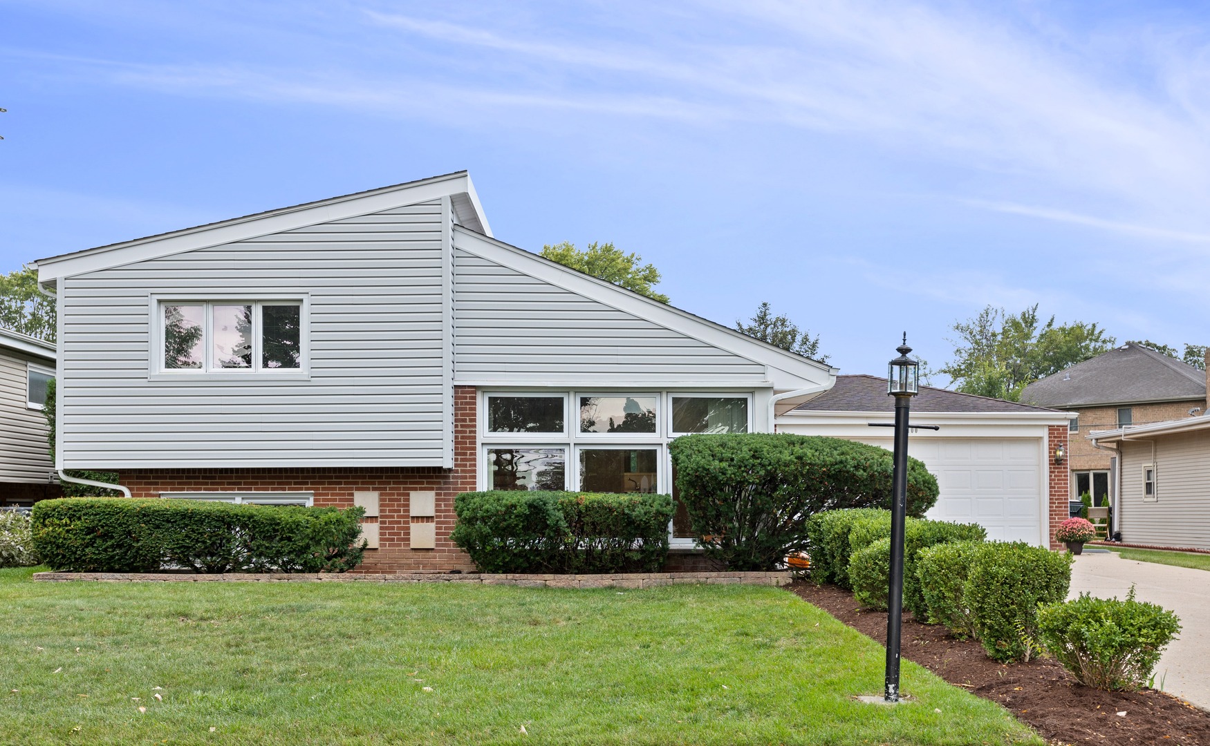 9400 Octavia Avenue Morton Grove, IL 60053 - Photo 1 of 2 a front view of a house with a yard