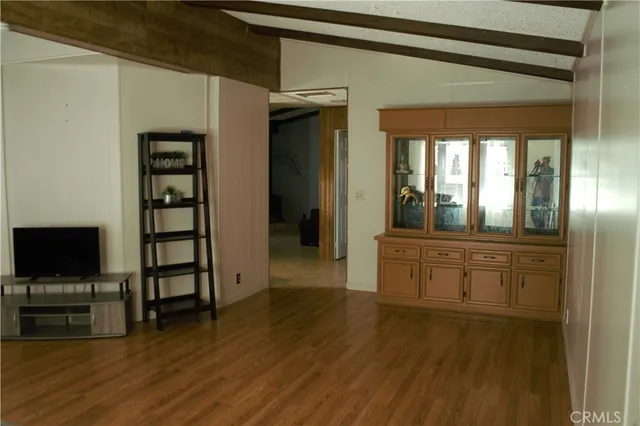 a kitchen with stainless steel appliances a stove and white cabinets
