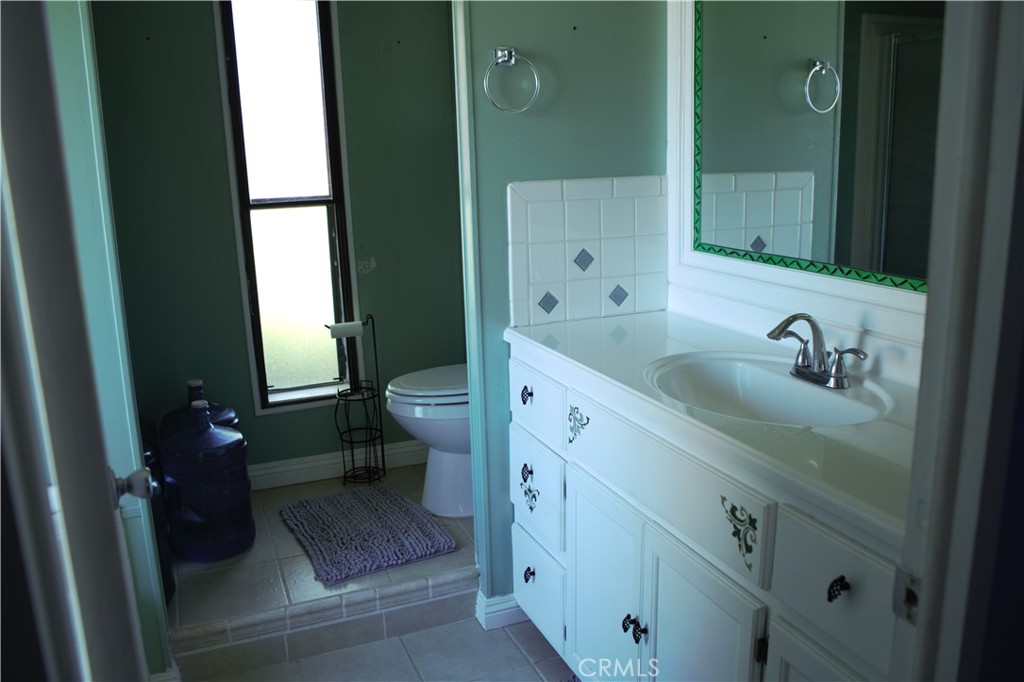 58870 Granite Gulley Road Anza, CA 92539 - Photo 24 of 29 a bathroom with a sink a toilet and shower