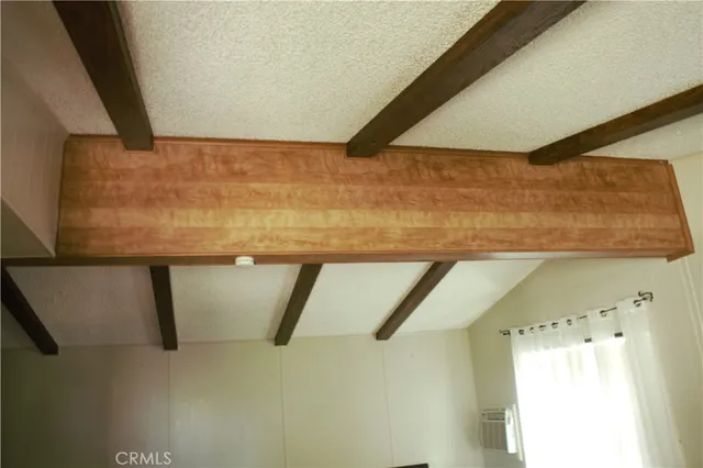 a view of a livingroom with wooden floor and a flat screen tv