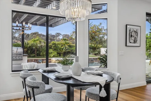 a large white kitchen with a large window and breakfast area