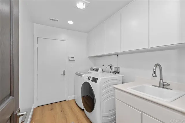 a view of a hallway to a livingroom with furniture