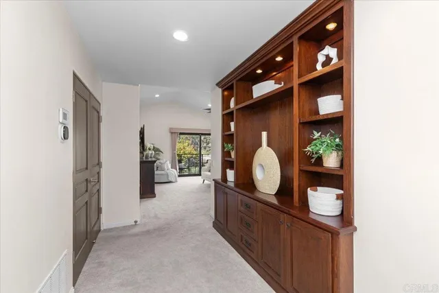 an empty room with window and ceiling fan