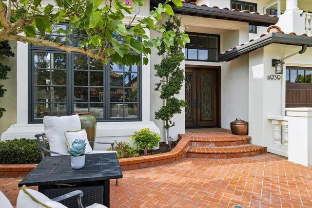 a view of a house with pool and chairs
