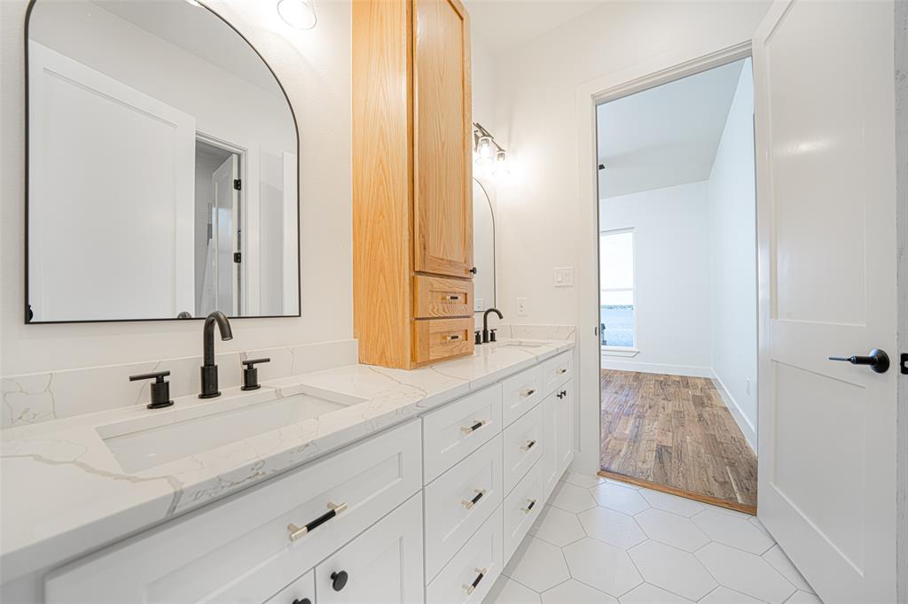 643 North Private Road Leesburg, TX 75451 - Photo 24 of 40 a bathroom with a double vanity sink and mirror
