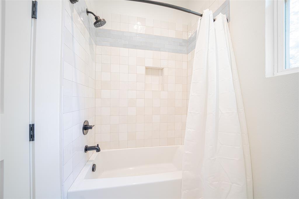 643 North Private Road Leesburg, TX 75451 - Photo 25 of 40 a bathroom with a shower and a bathtub
