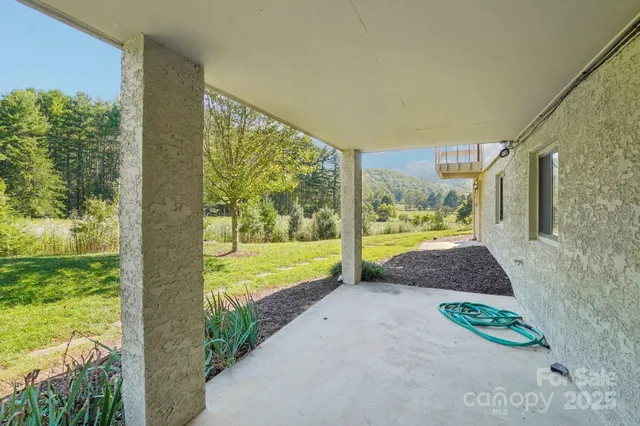 a view of a hallway with wooden floor and entryway