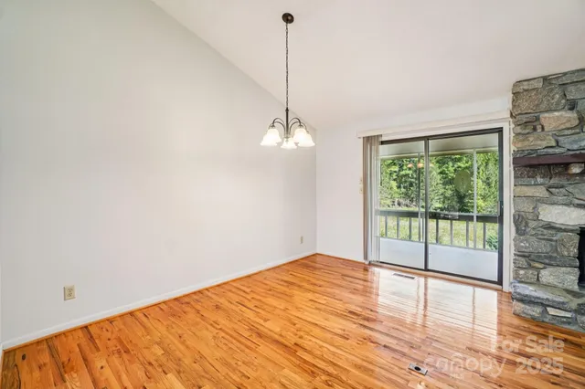 a view of a room with wooden floor and fan