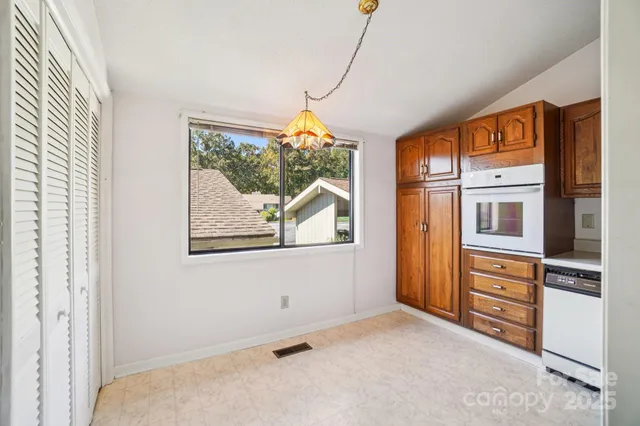 a kitchen with granite countertop a stove a sink and a refrigerator