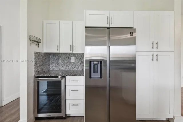 a kitchen with cabinets and stainless steel appliances