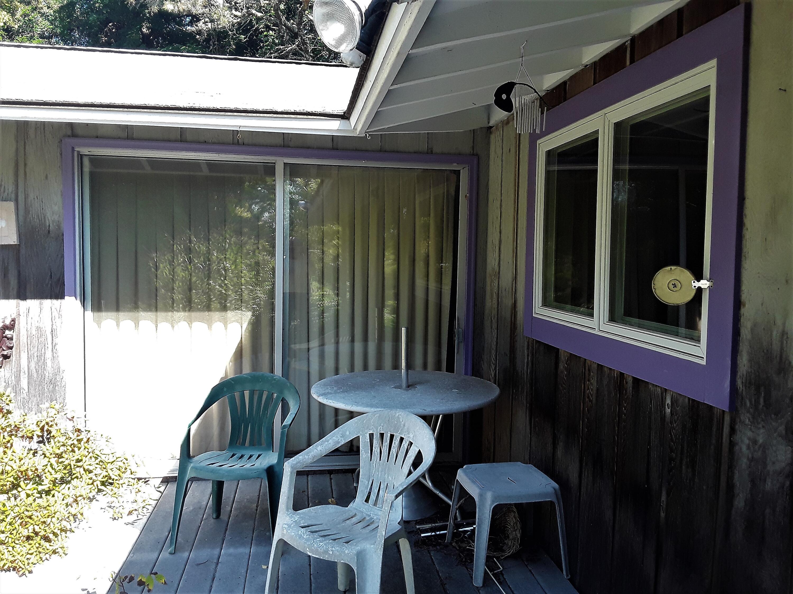 60 Cedar Land Road Orleans, MA 02653 - Photo 12 of 30 a view of a porch with a table and chairs