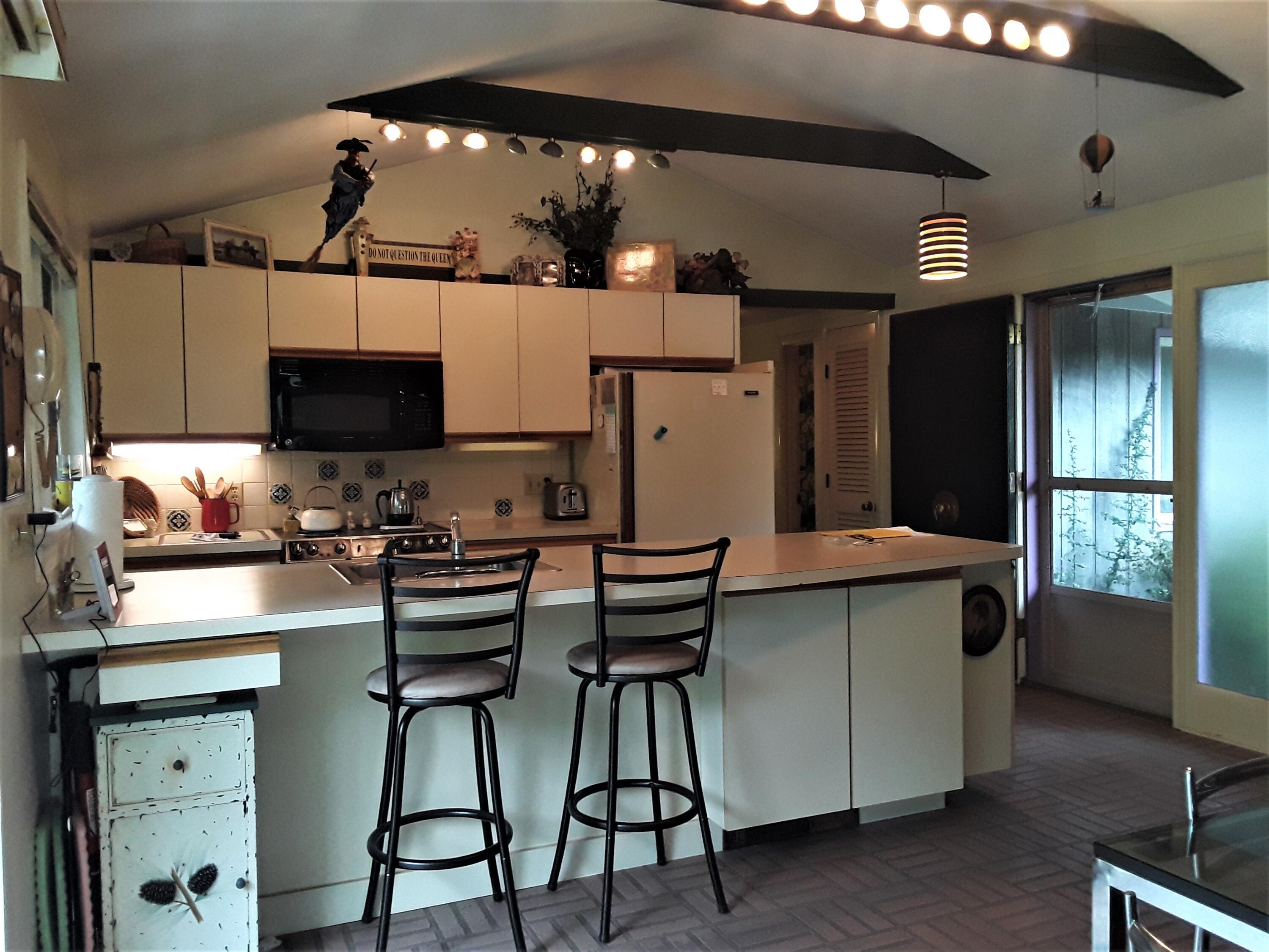 60 Cedar Land Road Orleans, MA 02653 - Photo 8 of 30 a kitchen with stainless steel appliances a stove a refrigerator and a stove