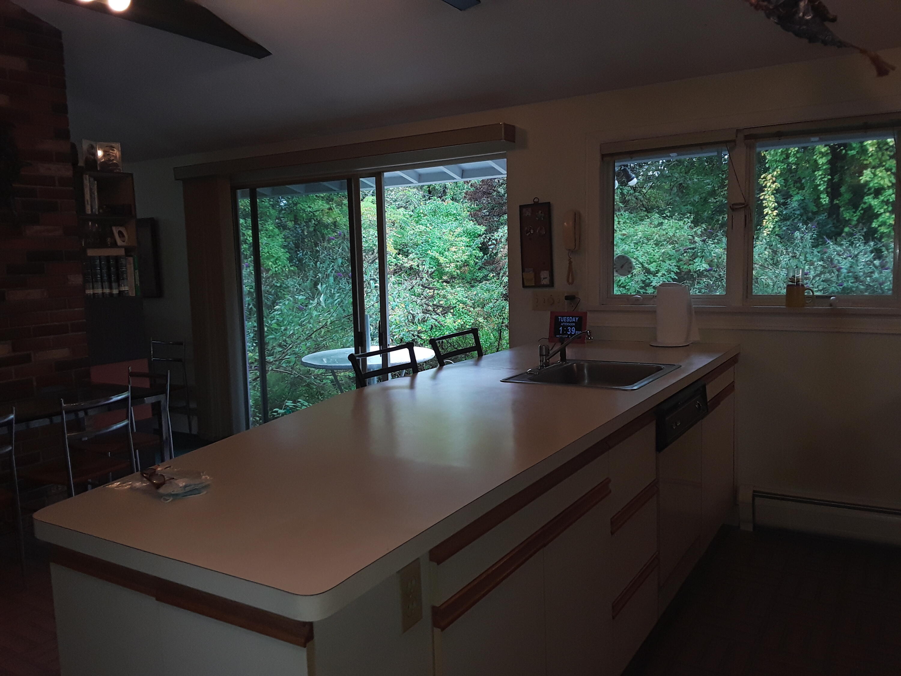 60 Cedar Land Road Orleans, MA 02653 - Photo 10 of 30 a view of kitchen island with stainless steel appliances granite countertop a sink a counter space and dining table