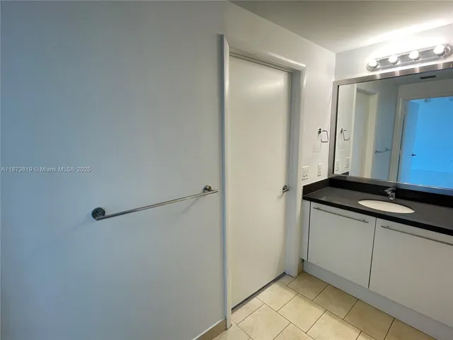 a bathroom with a double vanity sink and mirror