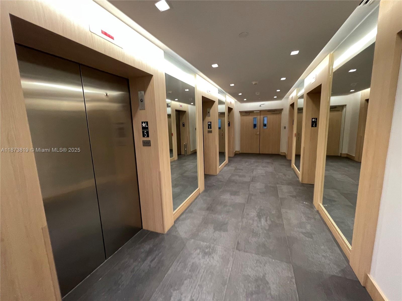 90 Southwest 3rd Street, Unit 1809 Miami, FL 33130 - Photo 27 of 35 a view of hallway with stainless steel appliances a refrigerator and cabinets