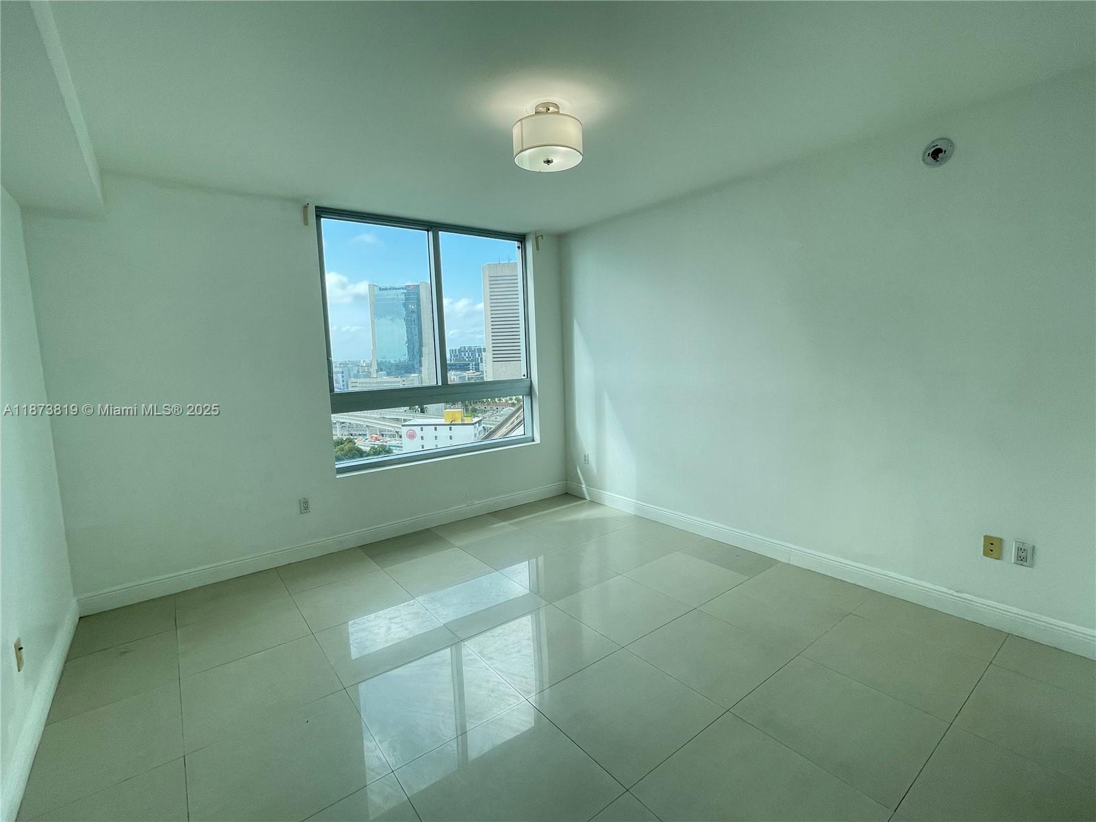 90 Southwest 3rd Street, Unit 1809 Miami, FL 33130 - Photo 8 of 35 a view of an empty room with a window