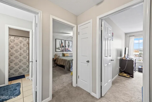 a bedroom with a bed dresser and a window