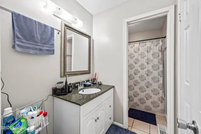 a bedroom with a bed and windows