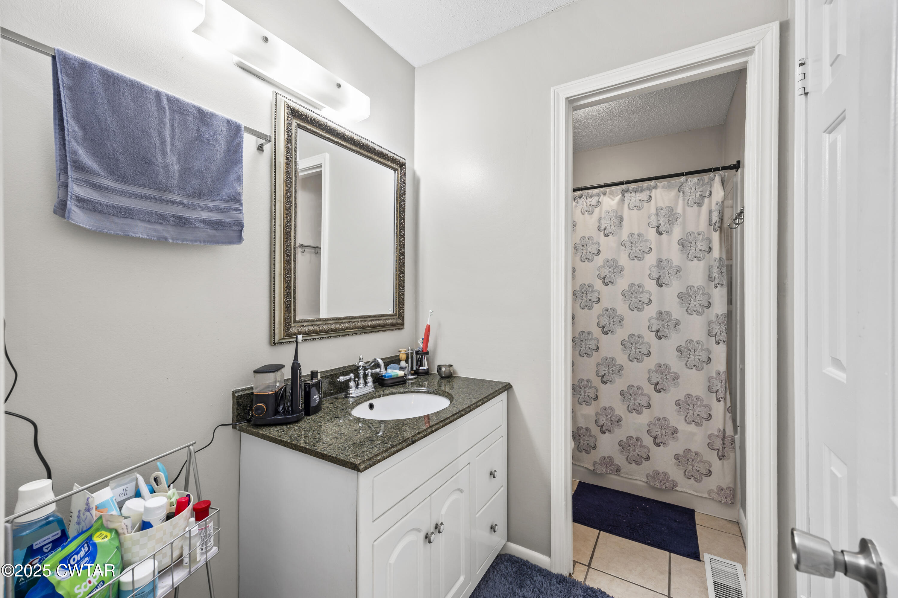 645 Walker Road Jackson, TN 38305 - Photo 13 of 16 a bathroom with a sink and a mirror