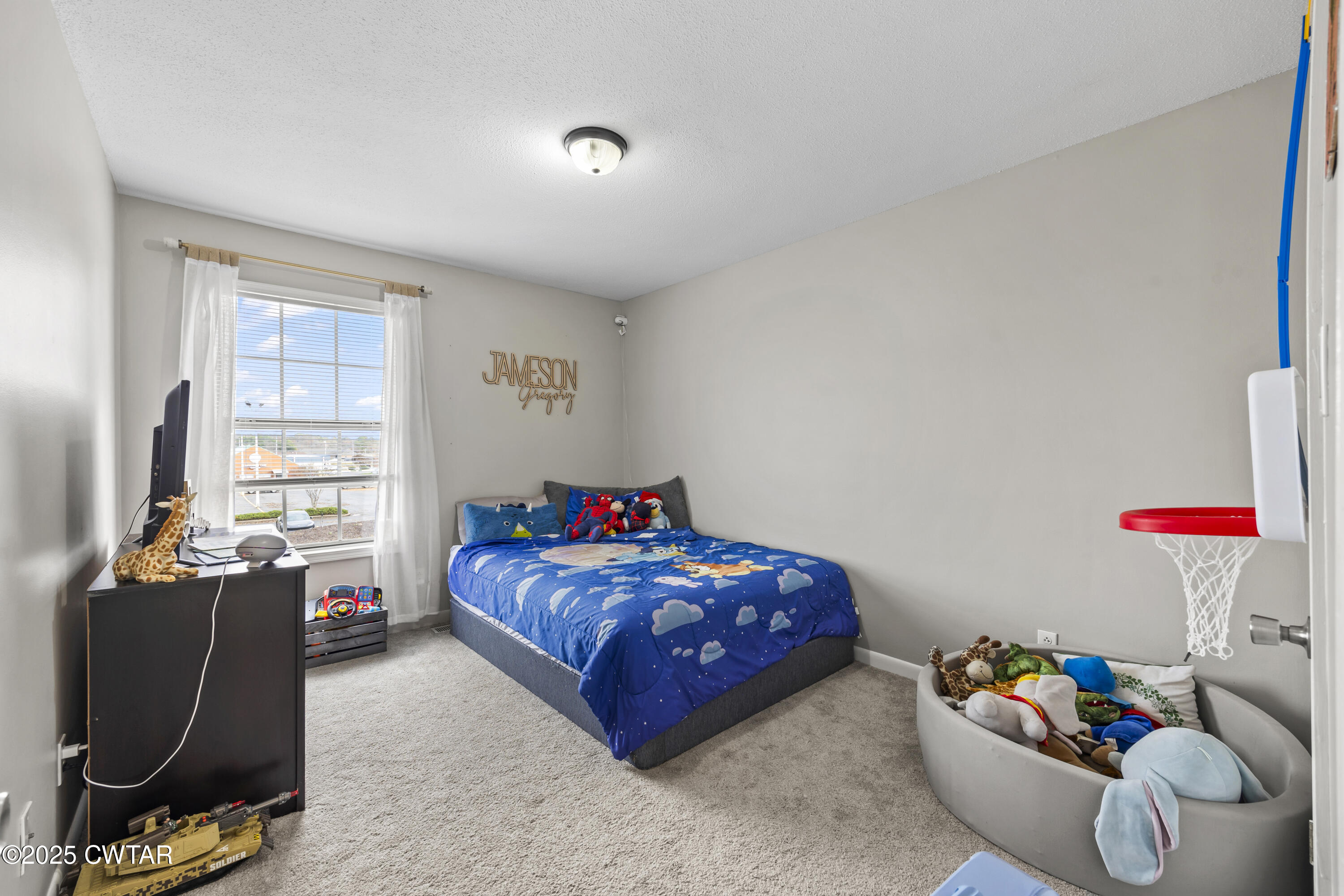 645 Walker Road Jackson, TN 38305 - Photo 14 of 16 a bedroom with a bed and windows