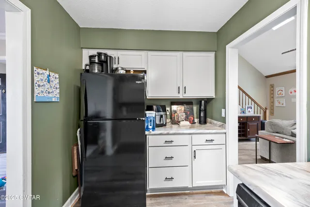 a kitchen with stainless steel appliances a refrigerator and cabinets