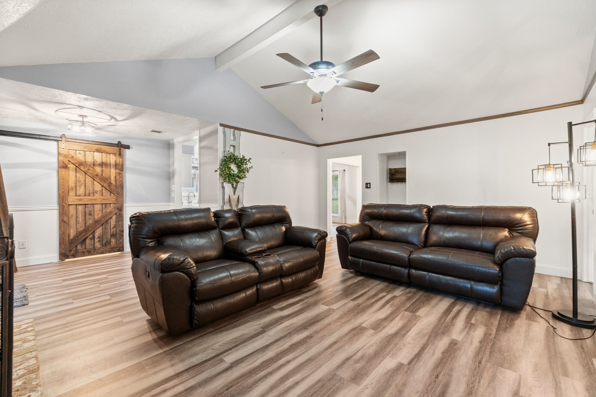 17610 Crestline Road Humble, TX 77396 - Photo 11 of 36 a living room with a couch wooden floor and a chandelier