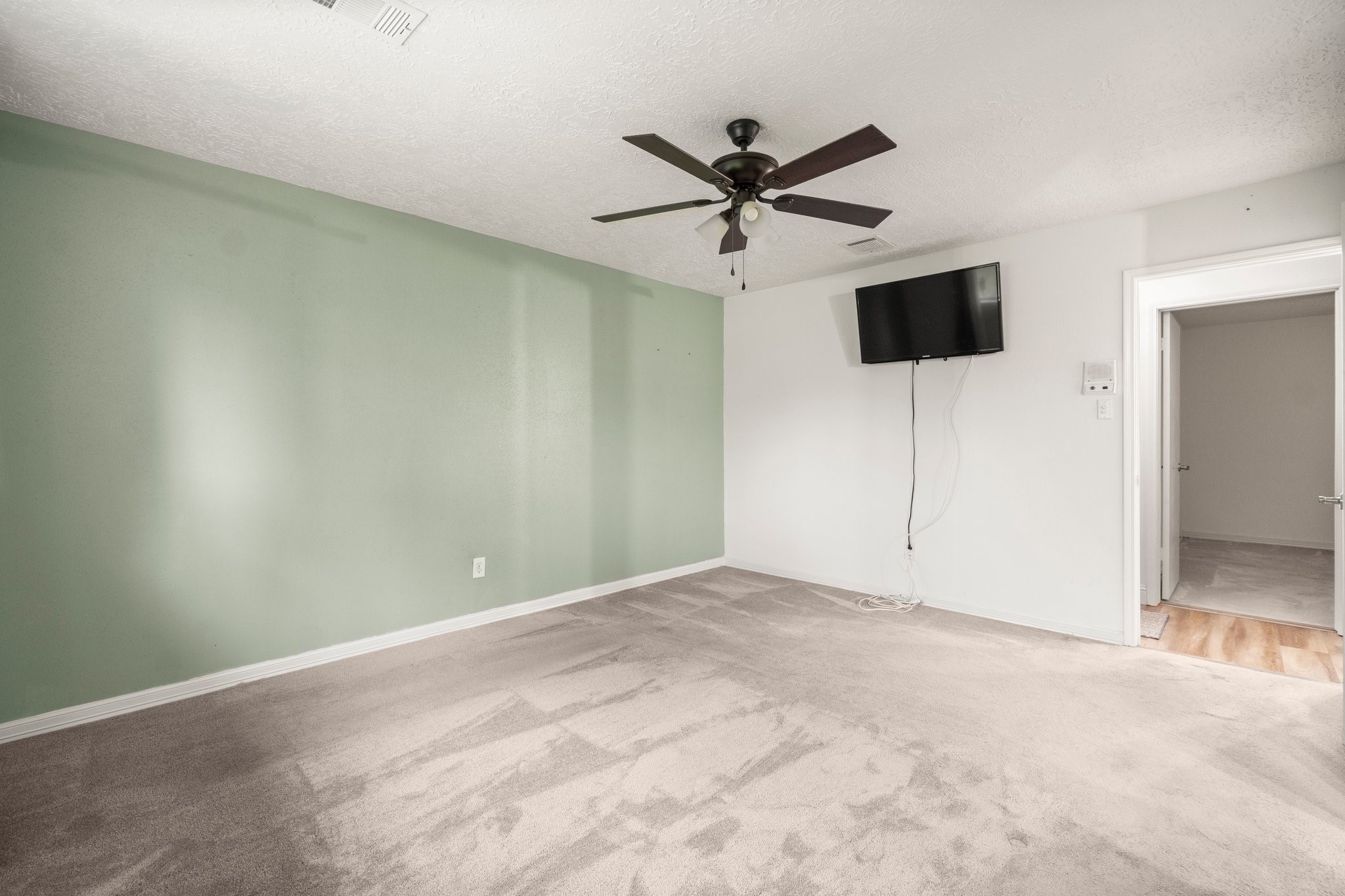17610 Crestline Road Humble, TX 77396 - Photo 24 of 36 a view of a big room with wooden floor and windows