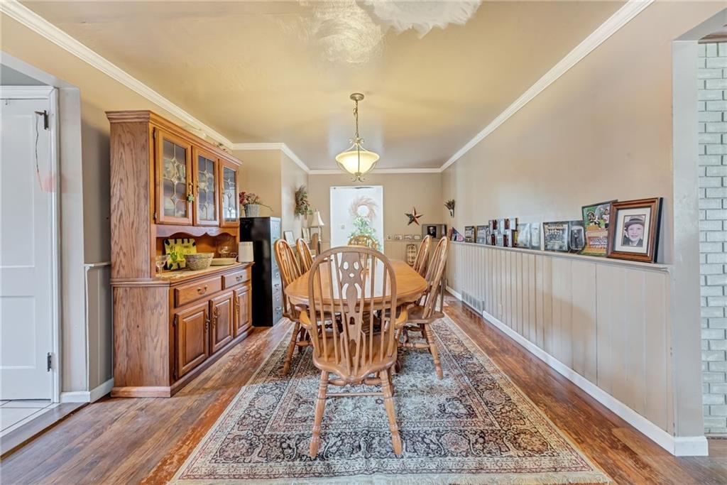 1017 McCoy Road McKees Rocks, PA 15136 - Photo 15 of 33 a dining room with stainless steel appliances granite countertop a couch dining table and a refrigerator