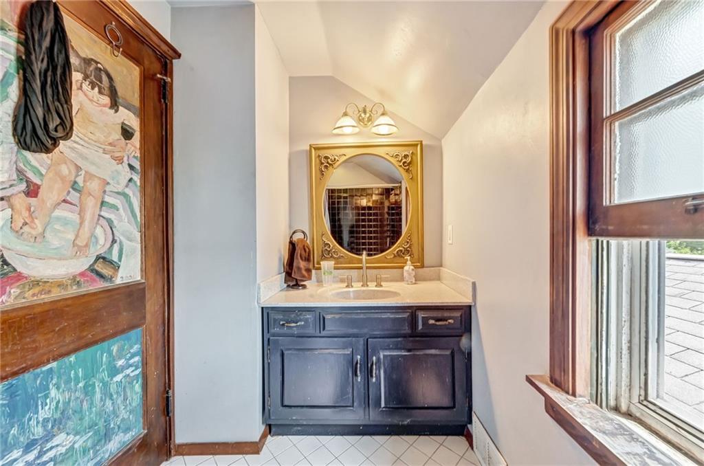 1017 McCoy Road McKees Rocks, PA 15136 - Photo 28 of 33 a bathroom with a granite countertop sink and a mirror