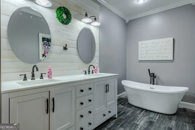 a view of a hallway with wooden floor and a livingroom