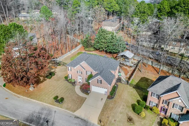 an aerial view of residential house with outdoor space and trees
