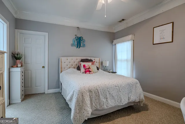 a view of a house with pool and sitting area