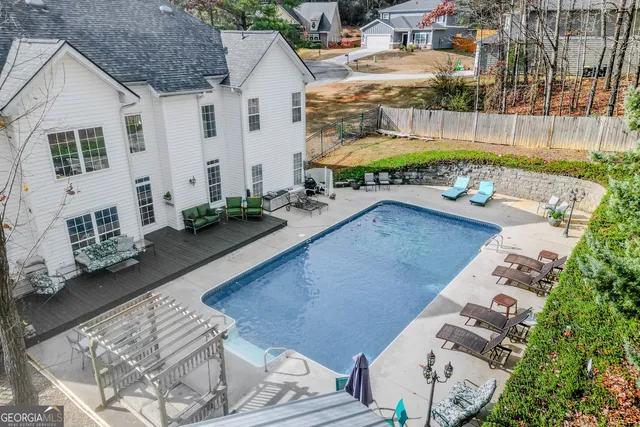 a dining room with wooden floor a chandelier a wooden table and chairs
