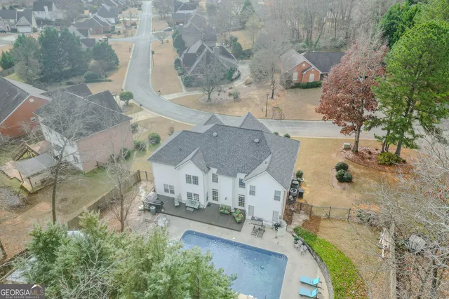 a dining room with wooden floor a chandelier a glass table and chairs