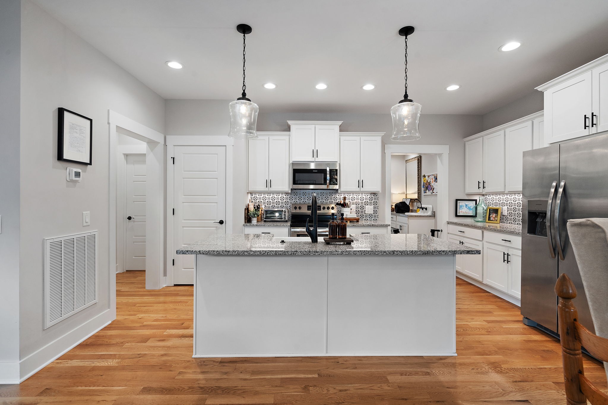 167 South Garner Street Springfield, TN 37172 - Photo 11 of 37 a kitchen with stainless steel appliances granite countertop a refrigerator a sink dishwasher a oven and a dining table with wooden floor