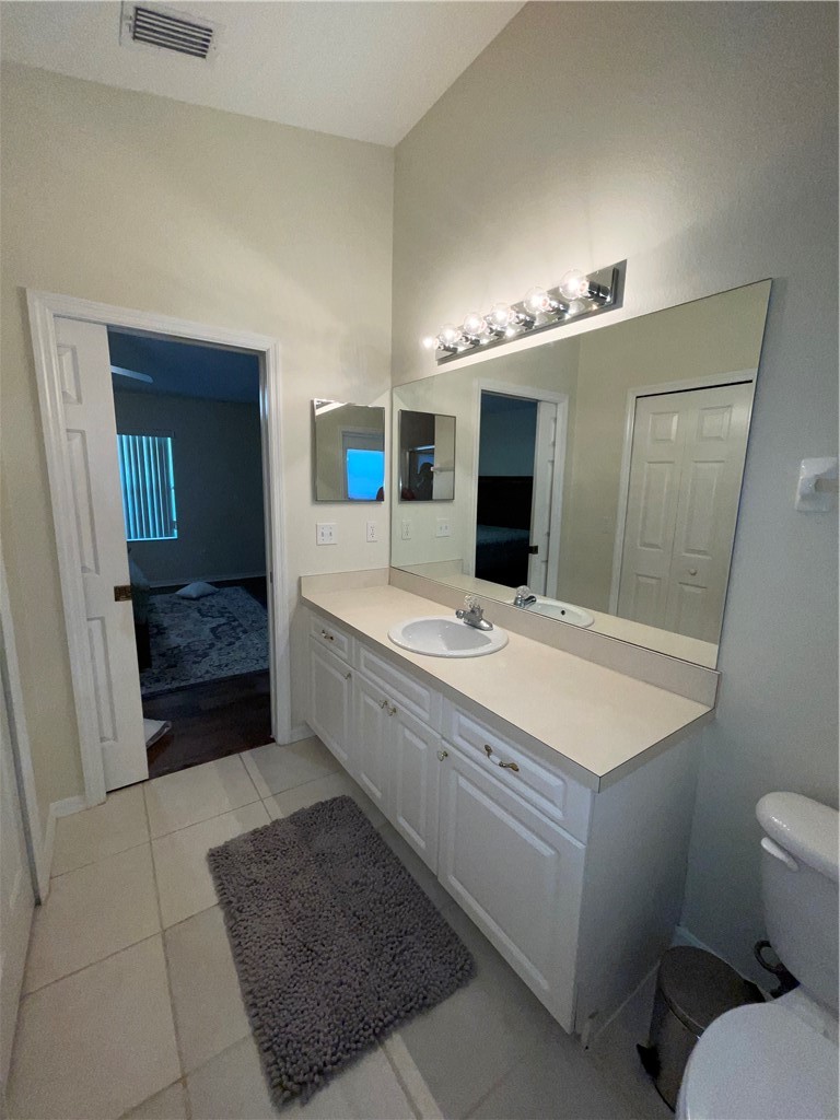 962 Montrose Avenue Sebastian, FL 32958 - Photo 12 of 30 a bathroom with a sink a toilet and mirror