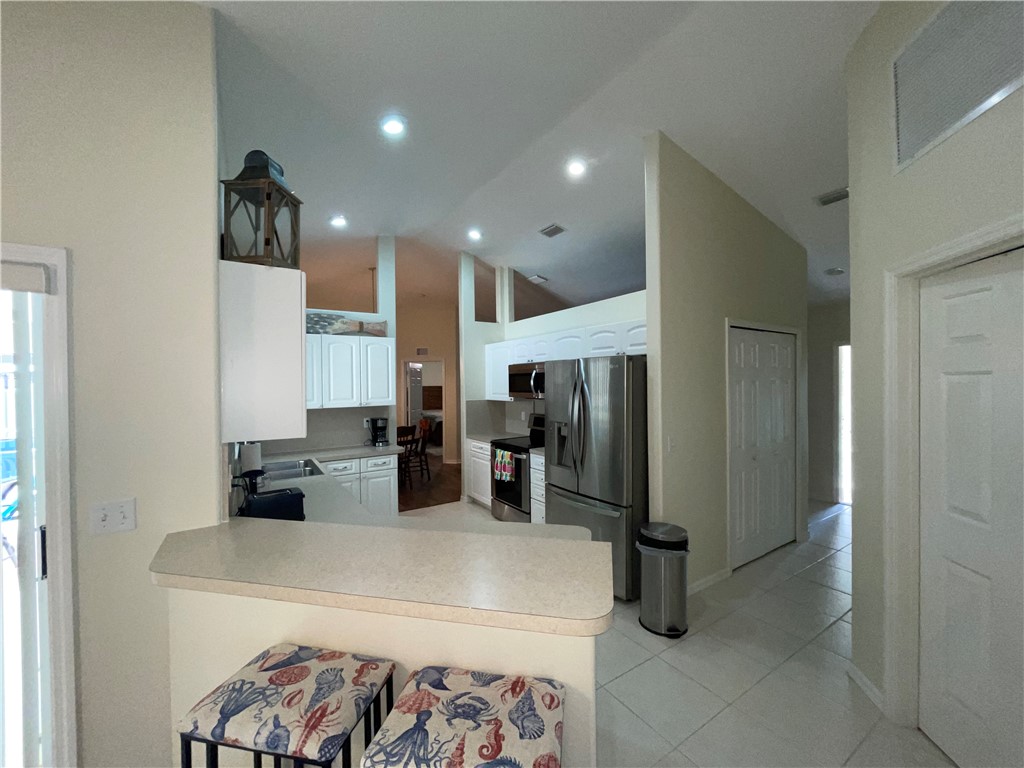 962 Montrose Avenue Sebastian, FL 32958 - Photo 7 of 30 a kitchen with a refrigerator and a sink