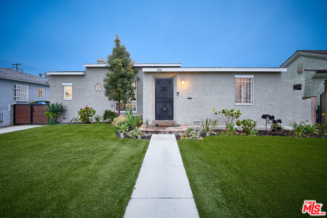 a front view of a house with a garden