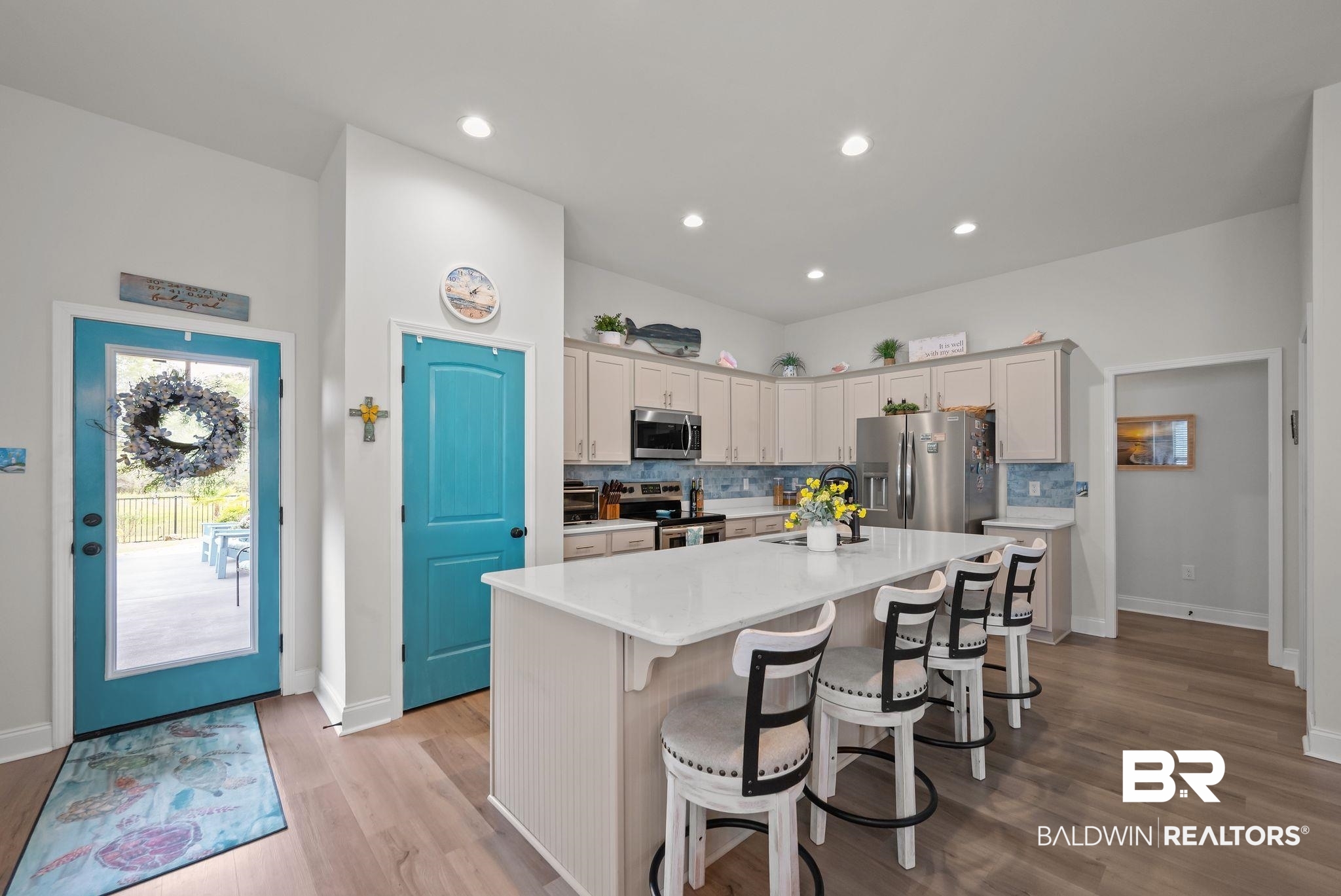 1165 Stella Road Foley, AL 36535 - Photo 11 of 42 Kitchen with appliances with stainless steel finishes, decorative backsplash, a kitchen island, light countertops, and a breakfast bar area