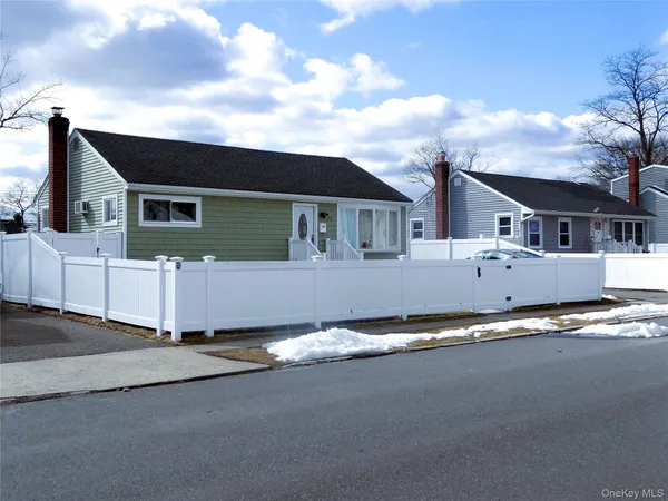 a front view of a house with a road